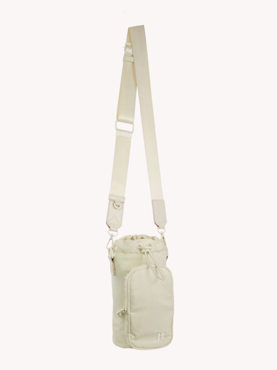 Front view of the beige antitheft travel water bottle with adjustable strap, antitheft locking system and front pocket to fit cards, iPhone and essential items