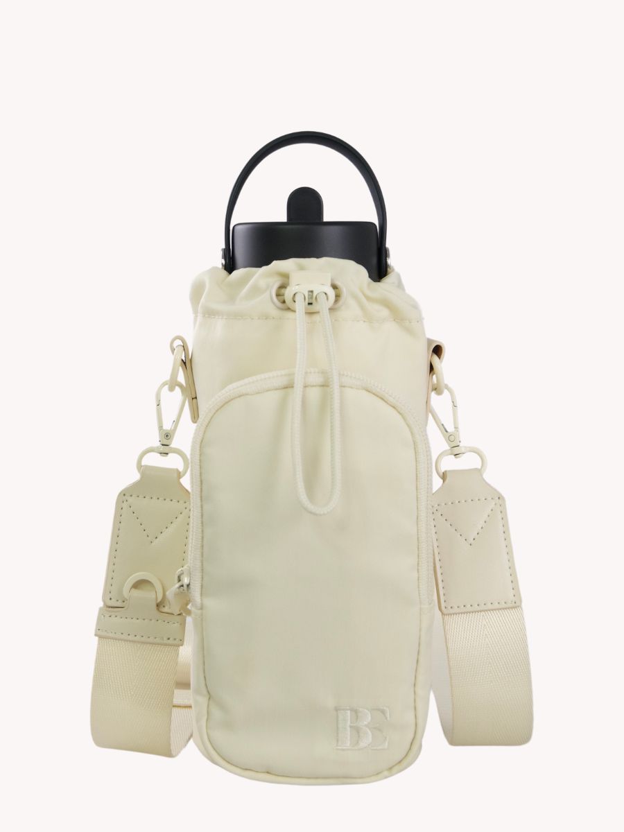 Front view of beige antitheft travel water bottle bag with adjustable strap