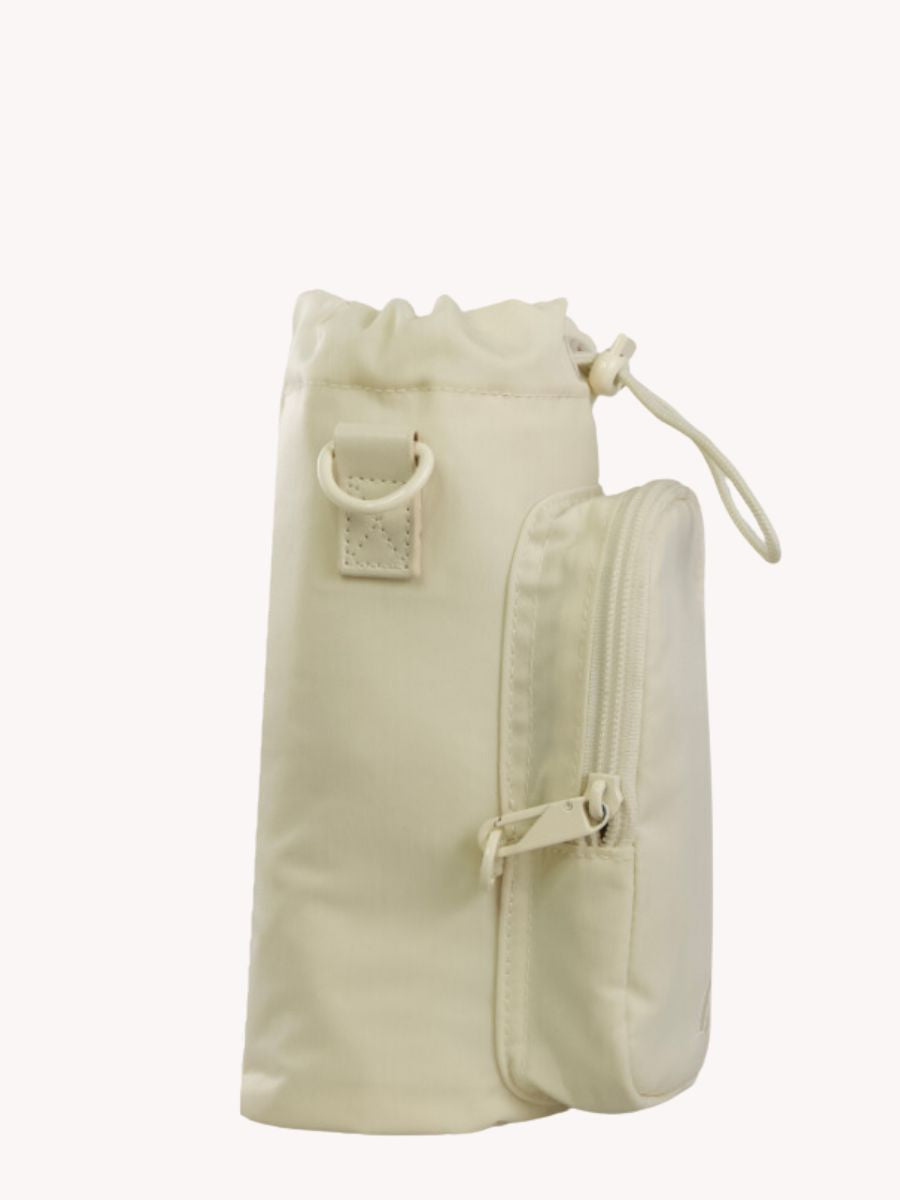 Beige anti theft water bottle bag from side view, with anti theft locking system on the front pocket to deter pickpockets when traveling